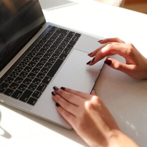 hands typing on laptop